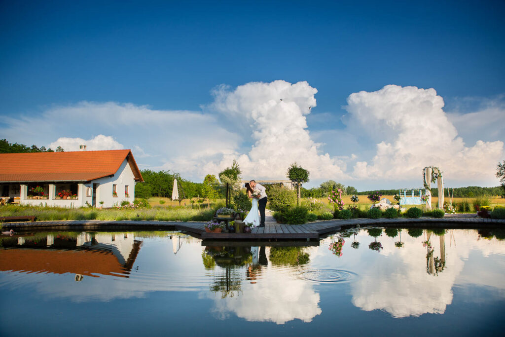 Blue sky clouds and wedding by a lake.