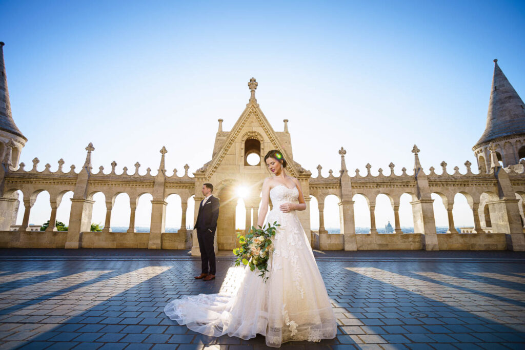 Bride and Groom in sunrise on a beautyfull castle. Flowers and long dress. Professional wedding phtographer