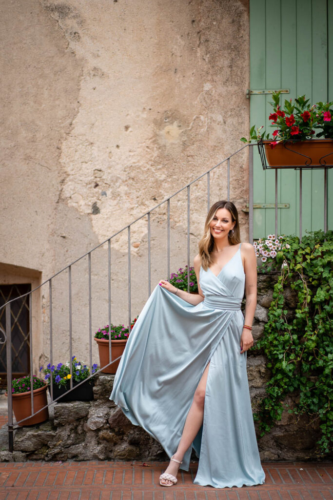 Woman in blue dress in Sirmione Italy. Professional wedding photographer
